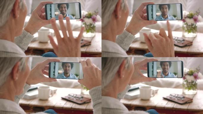 一名高级女子的手语、视频通话和电话交流，在家里给一名男子签名。一位聋哑老人使用技术在客厅里挥手致意，