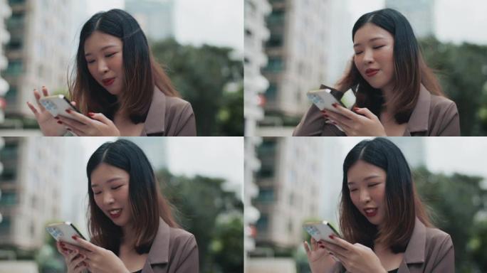 亚洲女性在城市使用智能手机
