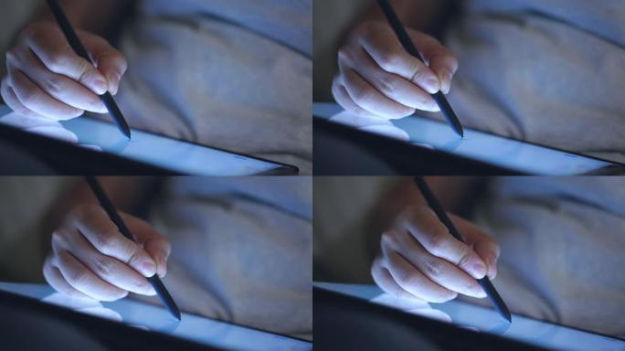 在数字平板电脑上使用数字铅笔画的手特写