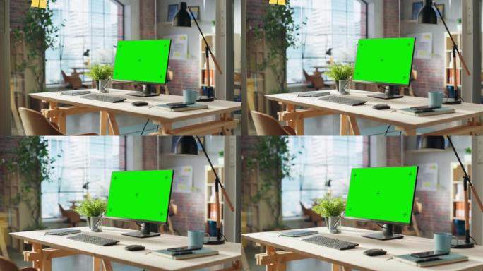 建立镜头: 台式电脑显示器，绿屏模拟色键显示器站在现代创意办公室的桌子上。阁楼大楼舒适的代理空间。