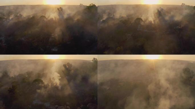 气候紧急情况。日落时分，草火燃烧的鸟瞰图非常靠近南部非洲的一个住宅区。火灾是由干旱和气候变化引起的