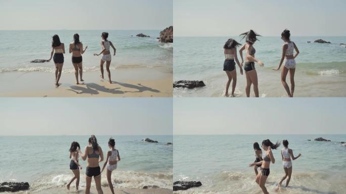 亚洲三个十几岁的女孩在夏天的海滩上玩耍，展示自由。东南亚和东亚: 海滩上的乐趣概念。