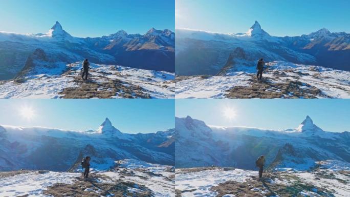 Man traveller在瑞士马特宏峰背景的山峰上拍照。