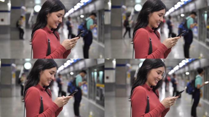 在地铁站使用智能手机的女人