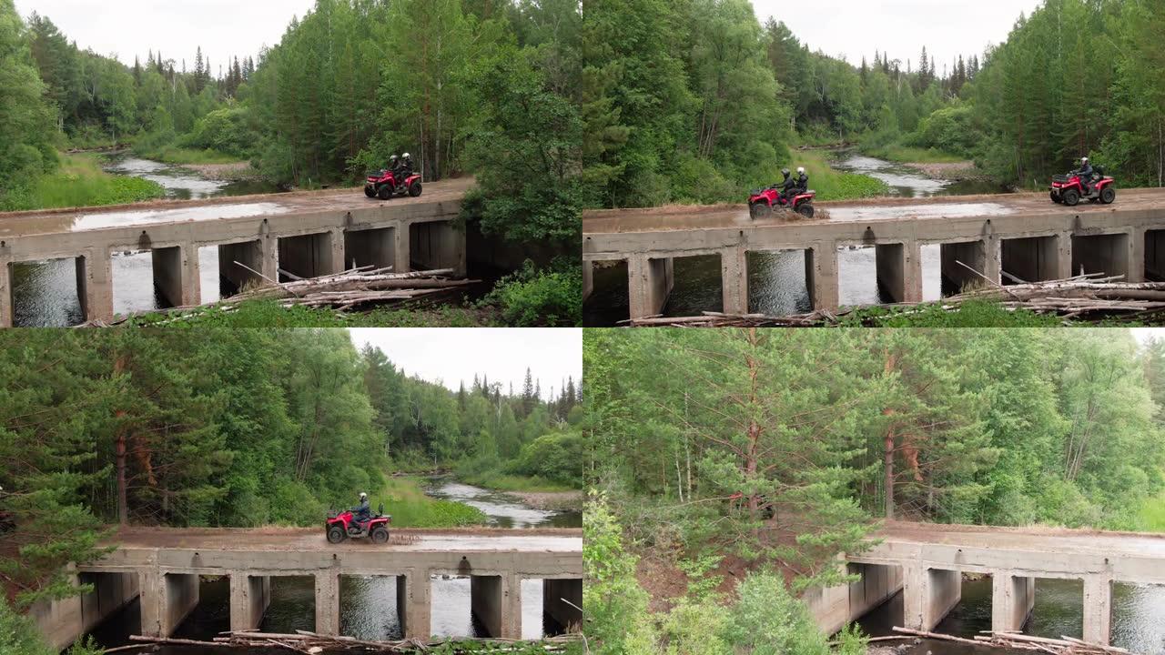 在森林中驾驶四轮摩托的人的无人机镜头