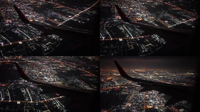 飞机机翼在夜间飞越城市