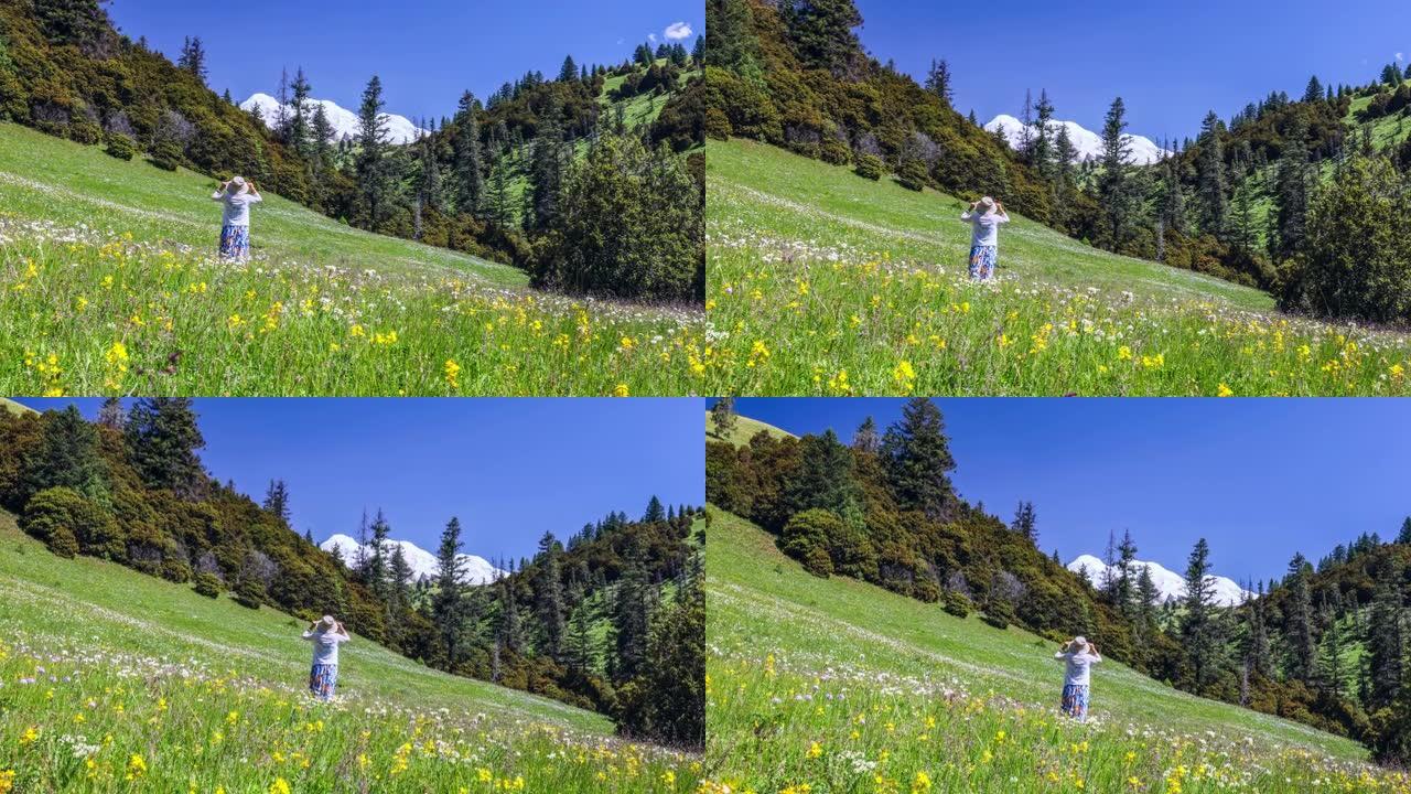 一名妇女站在川西的森林和鲜花中