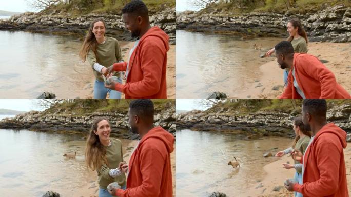 夫妇跳过石头外国人打水漂情侣约会户外玩耍