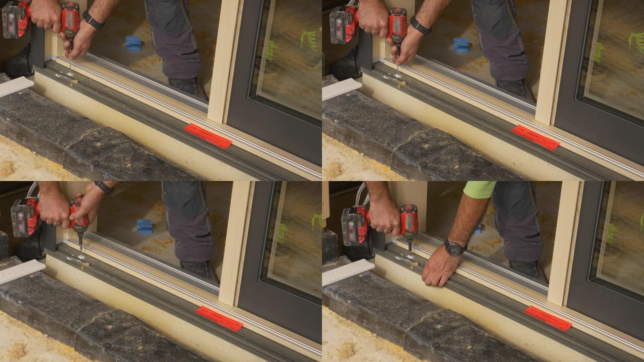 特写: 无法识别的承包商在安装窗户时钻一个孔。