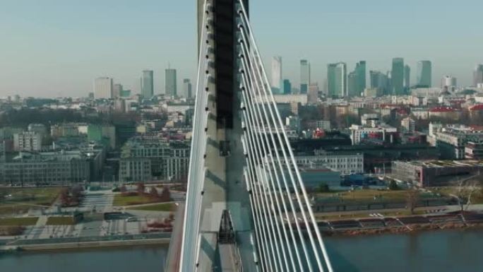 无人机在维斯拉河上空由现代电缆桥留下，揭示了波兰华沙美丽阳光明媚的城市天际线。