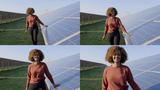 在太阳能电池板农场散步的非洲快乐妇女