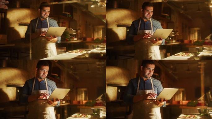 在餐厅: 英俊的男厨师使用笔记本电脑。正宗披萨店烹饪美味的有机生态食品。在小型企业家庭商店从事在线订