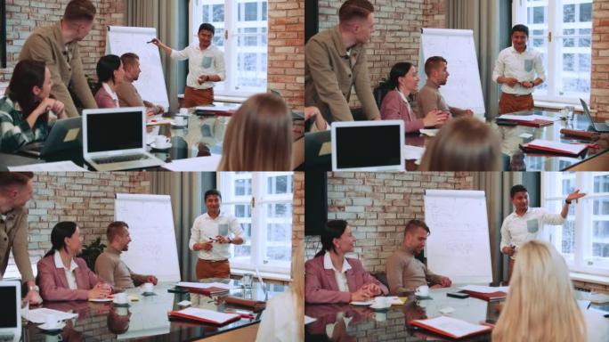 自信的印度男性商业教练，销售专家在办公桌上为经理举办的挂图领导研讨会上指出。