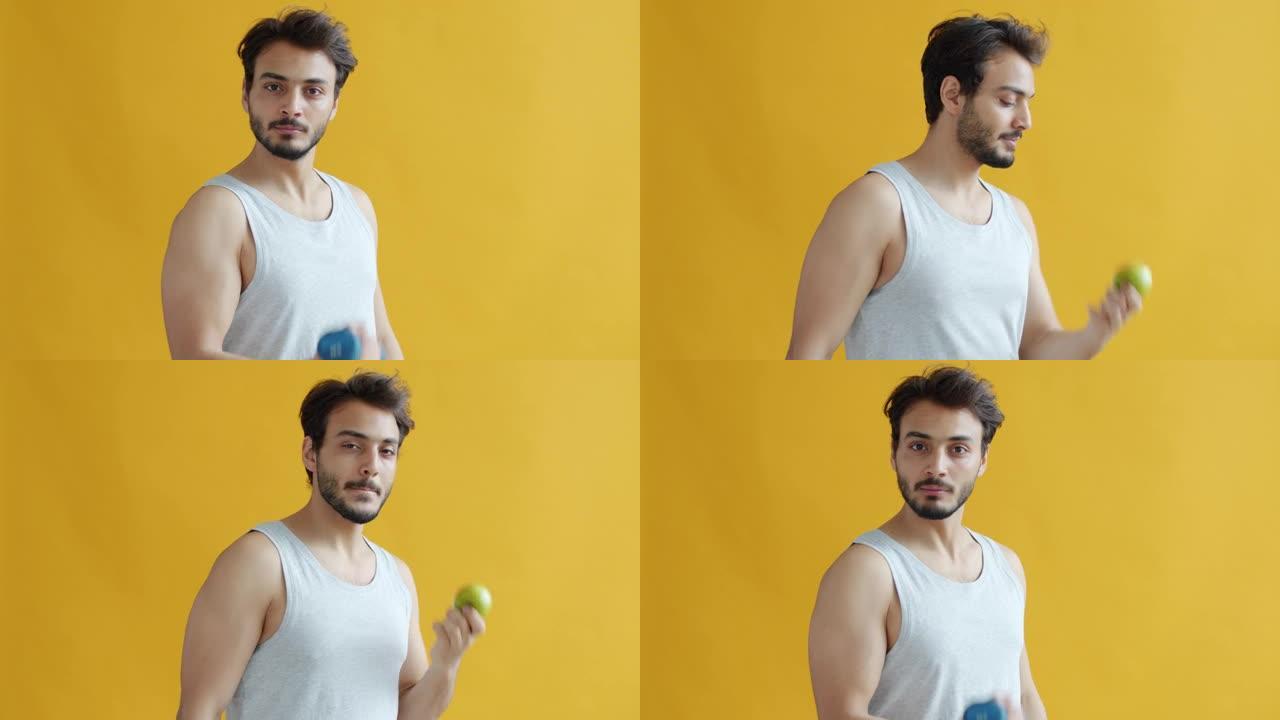 中东运动员用哑铃锻炼和吃苹果的肖像