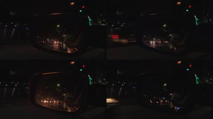 从汽车的侧视镜可以看到阿根廷布宜诺斯艾利斯的夜间交通。4k分辨率。