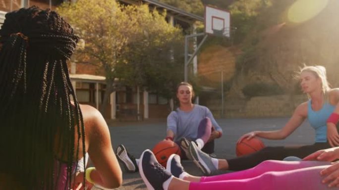 多样化的女子篮球队穿着运动服，伸展运动