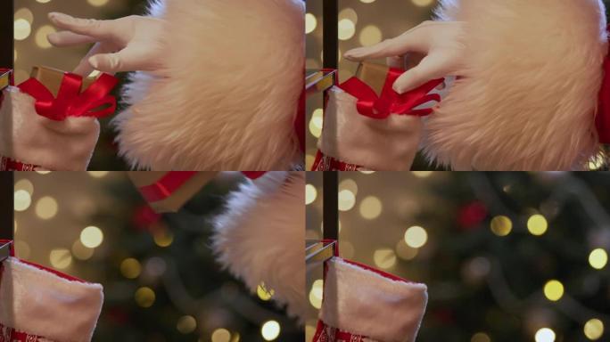 圣诞老人的手从圣诞节袜子中拿出礼物的特写镜头