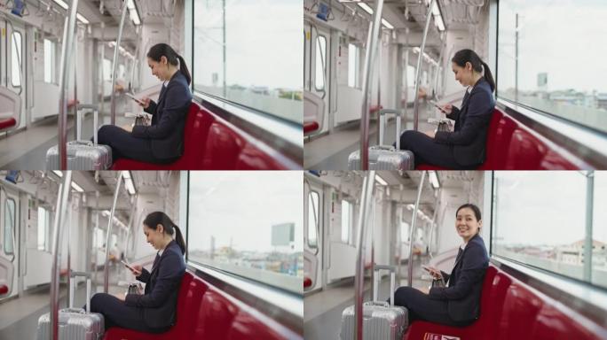 在火车上使用智能手机的女商人