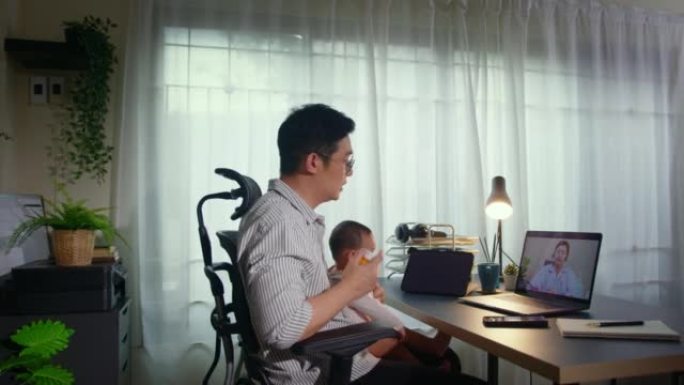 父亲在笔记本电脑上与儿科远程医疗交谈，向医生询问家中生病的男婴。虚拟护理远程医疗预约和在线咨询。