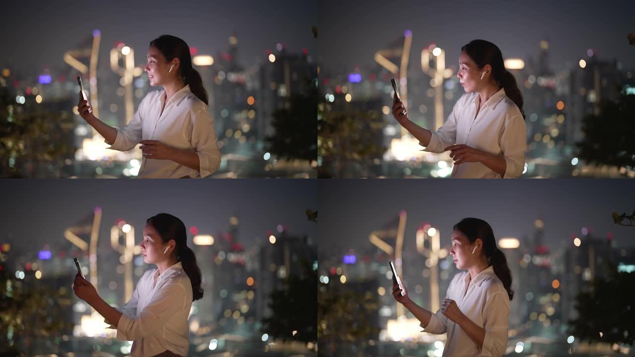 亚洲女商人在城市的手机上进行视频通话