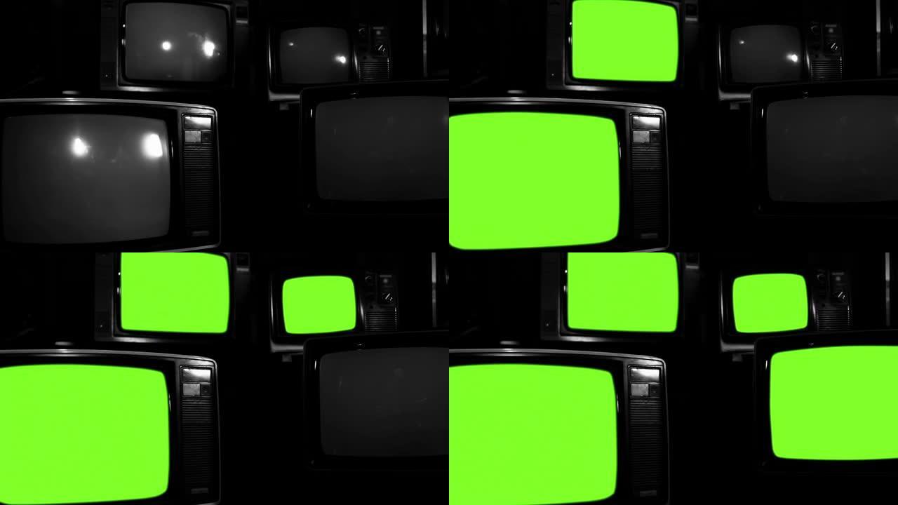 四台旧电视在黑暗的房间里打开绿色屏幕。放大。黑白色调。4k分辨率。