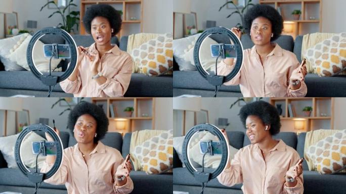 Afro美容影响者，vlogger或播客主持人交谈，使用电话拍摄带有新睫毛膏化妆的实时流化妆教程。兴