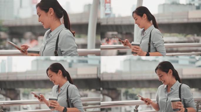 亚洲女子在城市中行走并使用智能手机