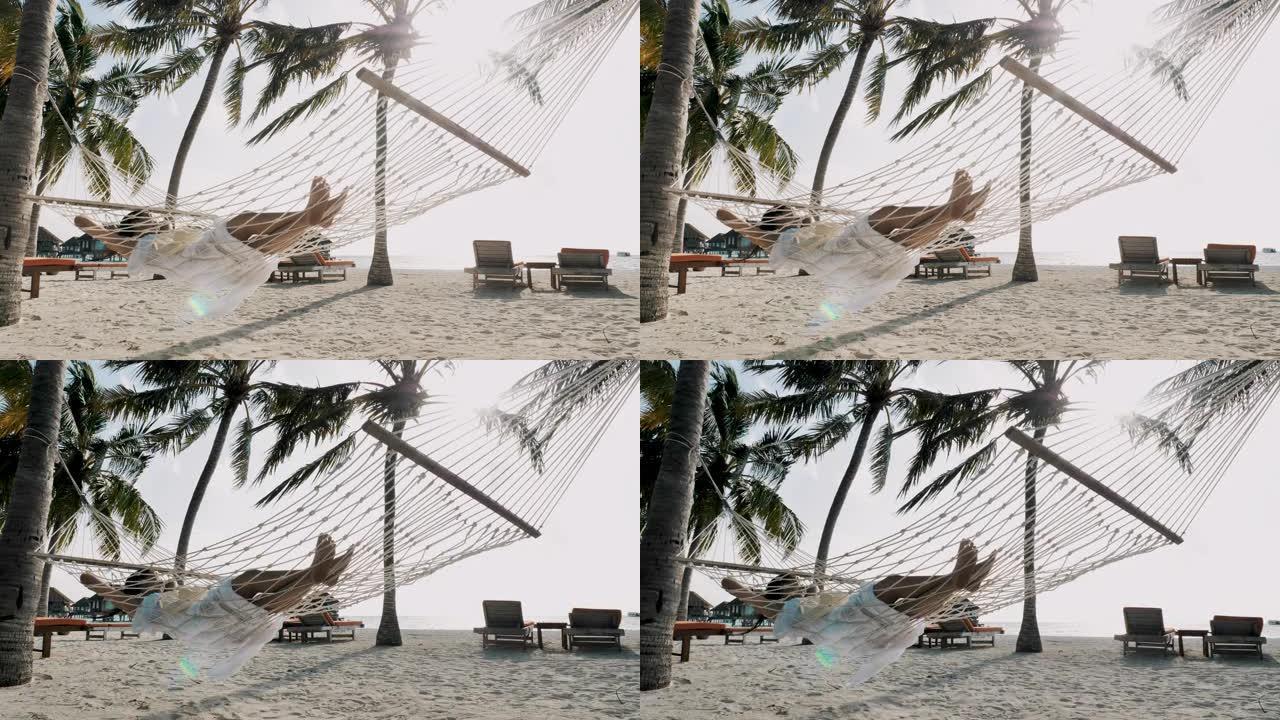 慢动作女人在热带海滩的吊床上放松，炎热的晴天