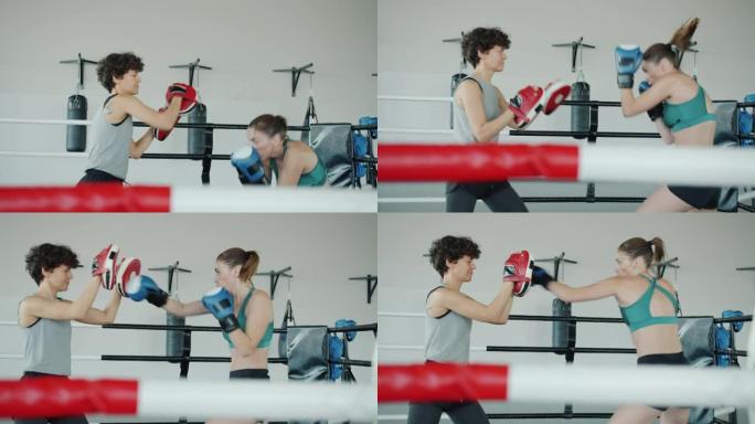 在健身房训练的年轻女性的慢动作享受拳击练习