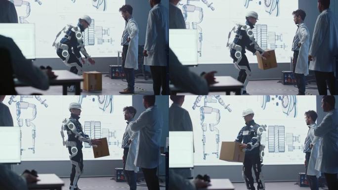 在开发实验室中: 工程师们正在研究机器人外骨骼原型演示，并进行人员测试，举起沉重的纸板箱。设计可穿戴