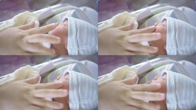 母亲分娩后在医院用爱心抚摸儿子新生儿