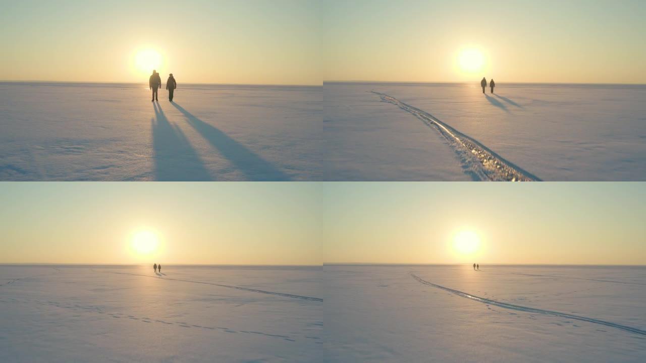 男人和女人在冰冷的雪域中跋涉