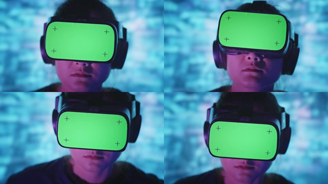 亚洲女人，家里的VR耳机上有色度键绿色屏幕，背景中有抽象的多色。