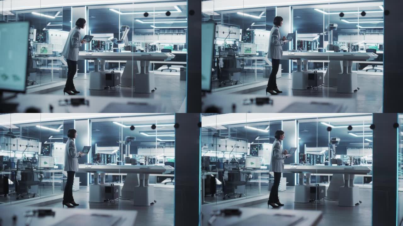 工业机器人工程师来到一家高科技工厂的带机械臂的桌子前。女科学家使用笔记本电脑来操纵和编程机器人来拾取