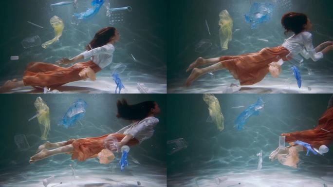 年轻的旅游女子游泳时，周围都是一次性塑料垃圾，在水下慢动作下污染。