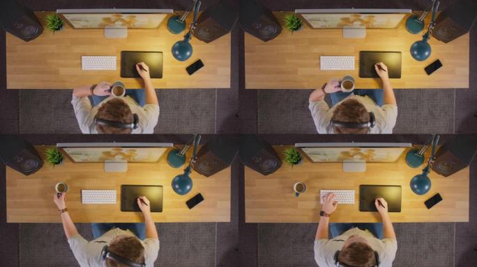 男性平面设计师或带有图形平板电脑的照片润饰的俯视图晚上在创意办公室的电脑上工作，喝咖啡-慢动作拍摄