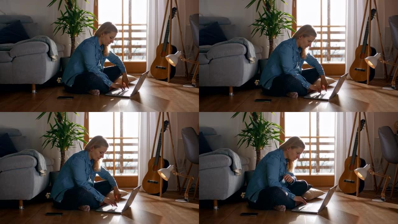 DS女人在地板上使用笔记本电脑