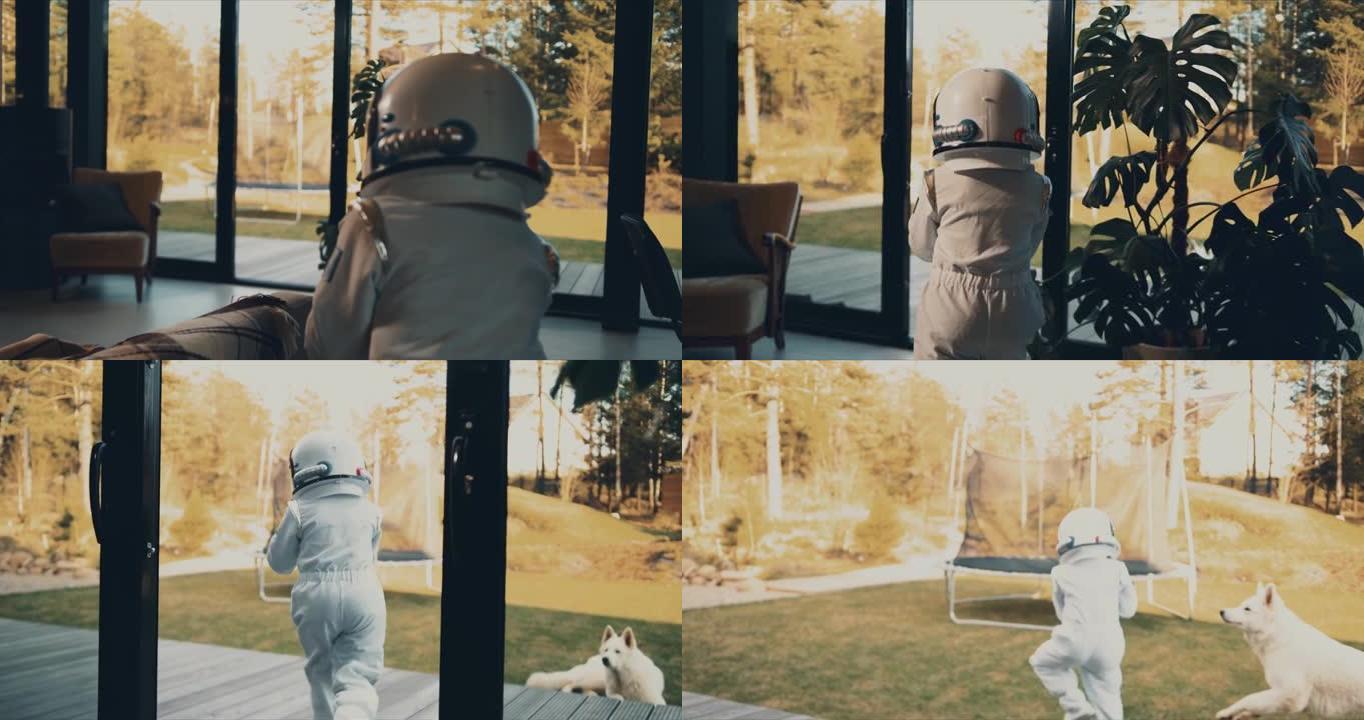 摄像机跟着小孩子带着狗跑出家门，穿着白色宇航员太空服和头盔来到露台蹦床。