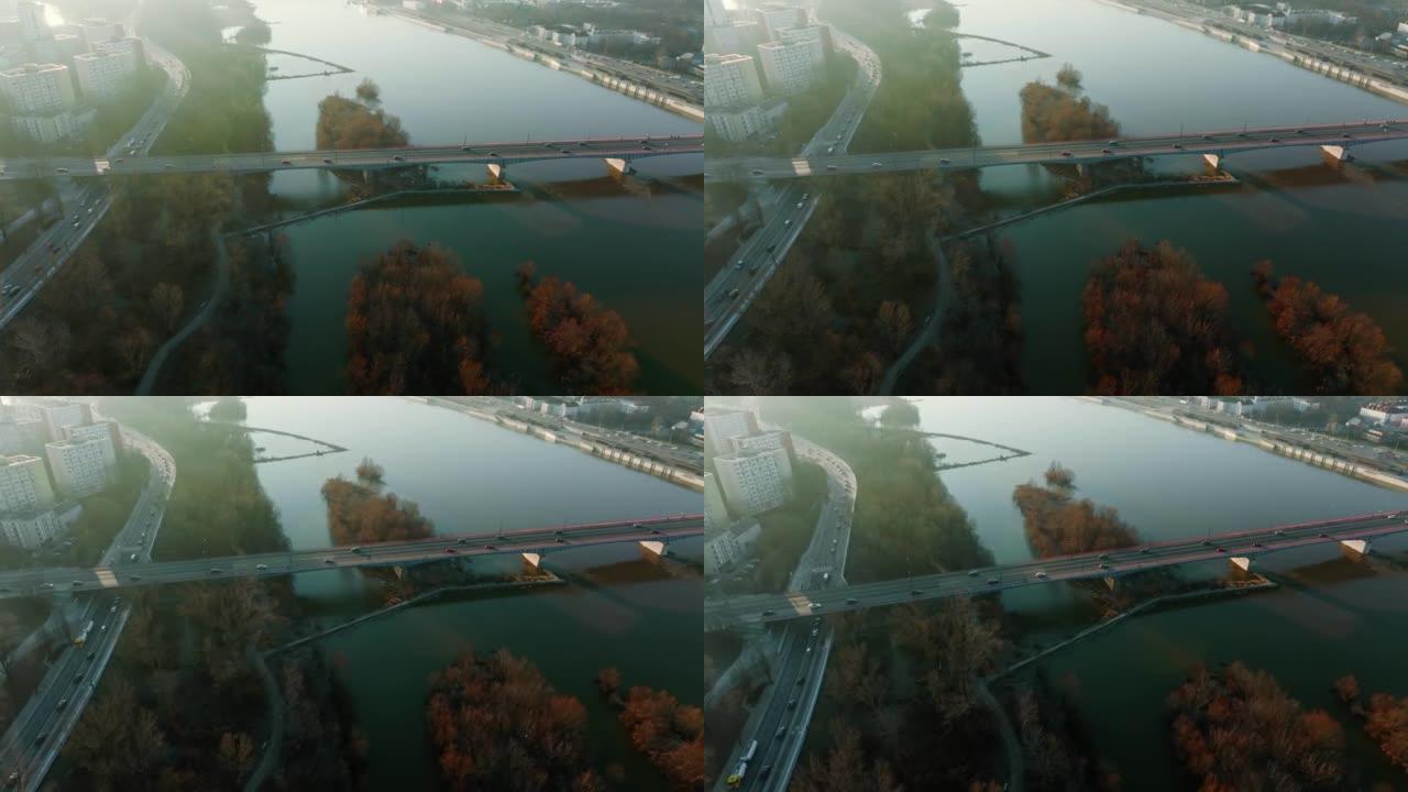 汽车在雄伟的桥上沿着维斯拉河移动。波兰华沙秋季日出的田园诗般的空中天桥拍摄