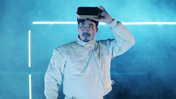 比赛结束后，男击剑手正在起飞VR设备。虚拟现实，增强现实游戏概念。