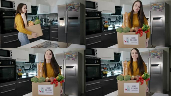 慢动作快乐的年轻女子将食品盒带入厨房