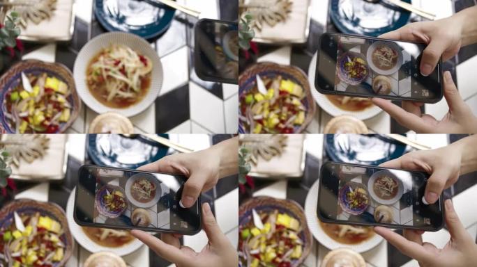 手持智能手机拍摄thaifood的照片
