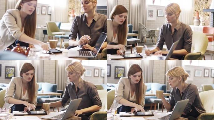 两名迷人的女商人坐在咖啡馆里使用技术的4k视频片段