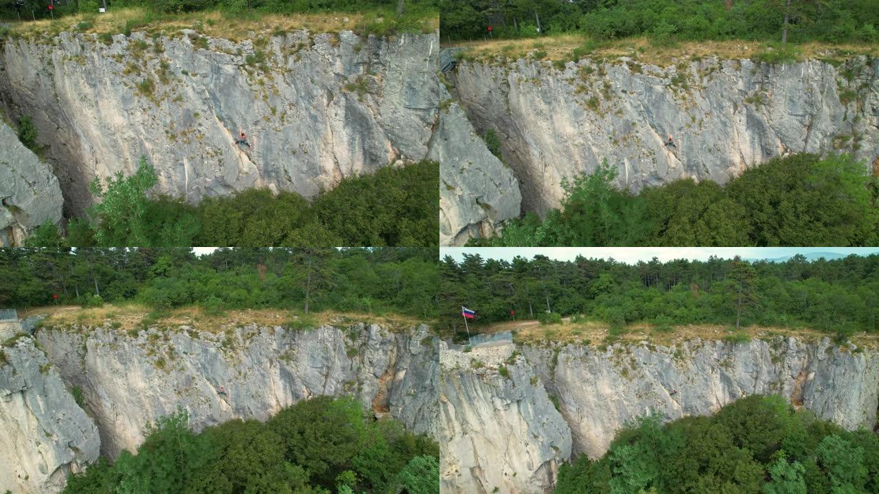 空中飞行: 在斯洛文尼亚农村的一个岩石悬崖上爬上一个女人的岩石上方飞行。