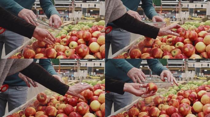 客户将苹果放在可重复使用的农产品袋中