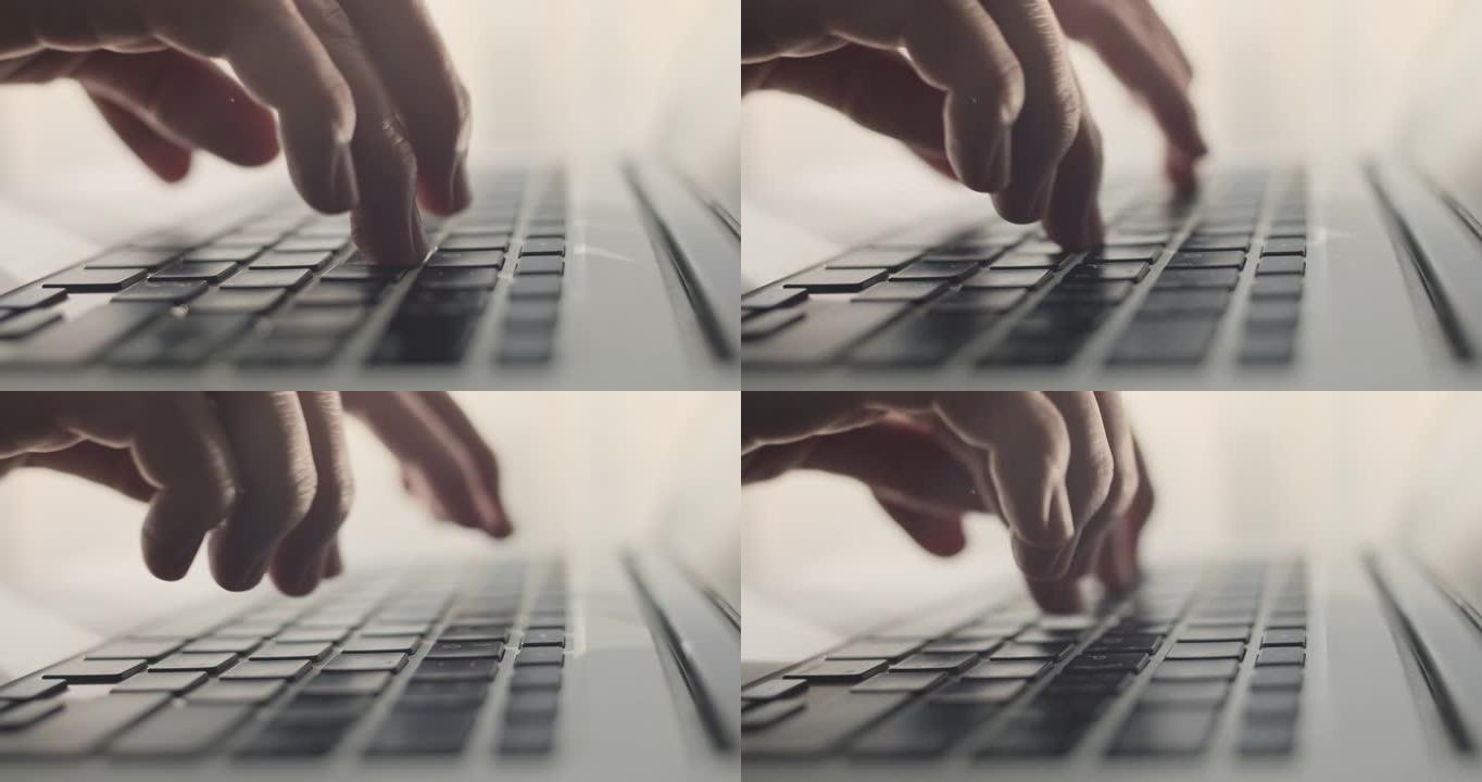 人手在笔记本电脑键盘上打字，特写