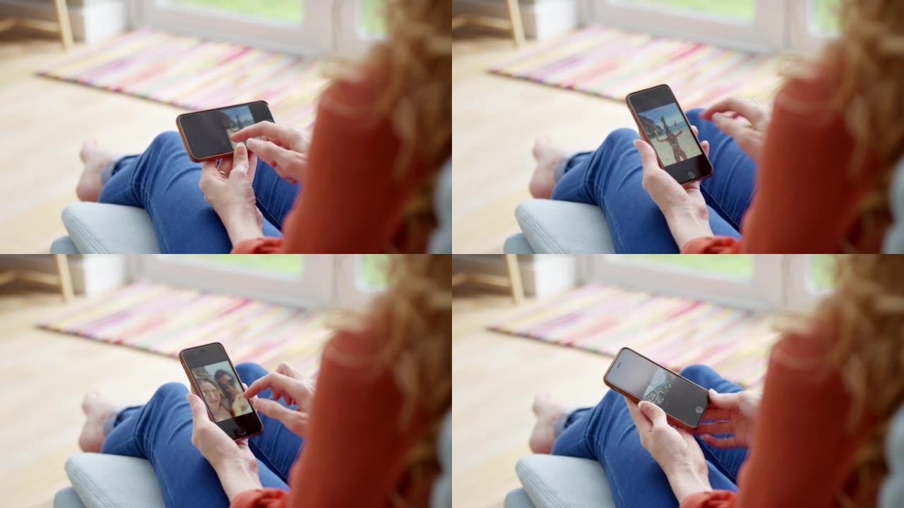 4k视频片段，一名妇女在智能手机上浏览照片