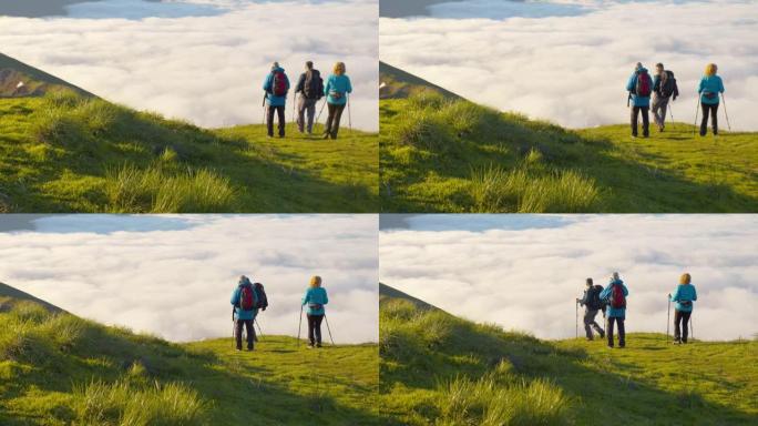 SLO MO三个徒步旅行者在山脊上行走