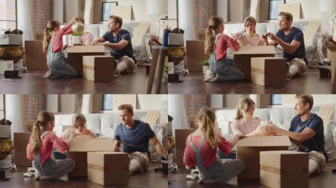 快乐的房主搬进来: 可爱的夫妇坐在舒适公寓的地板上打开纸板箱，小女儿加入了他们的行列。快乐的一天，幸