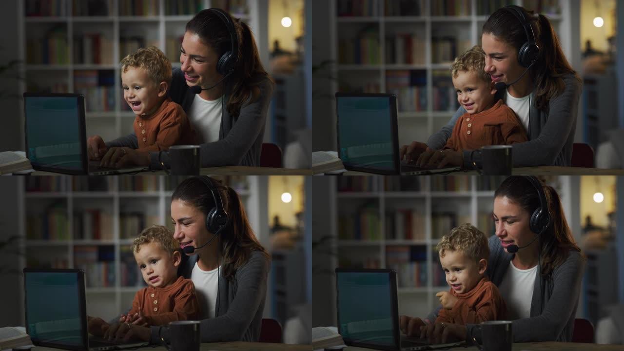 在家工作: 年轻母亲的肖像，她抱着可爱的蹒跚学步的孩子，白天在笔记本电脑上工作。成功的女经理在参加远